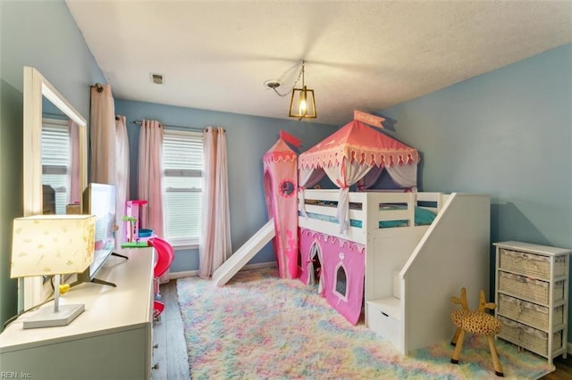 bedroom featuring visible vents and baseboards