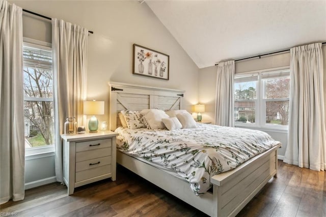 bedroom with dark wood-style floors, multiple windows, baseboards, and vaulted ceiling