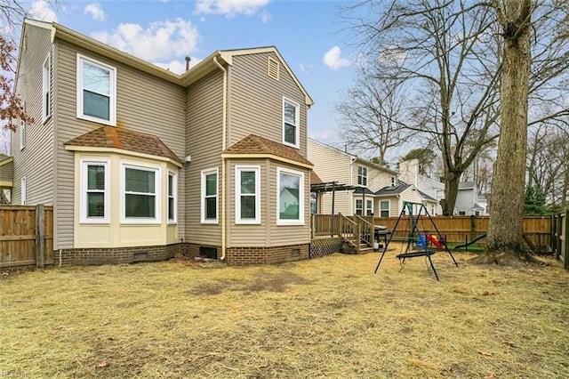 back of house featuring a shingled roof, crawl space, a fenced backyard, and a yard