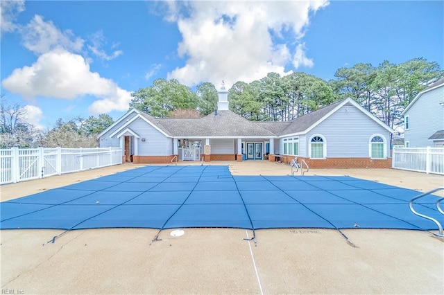 view of swimming pool featuring a patio area, fence, and a fenced in pool