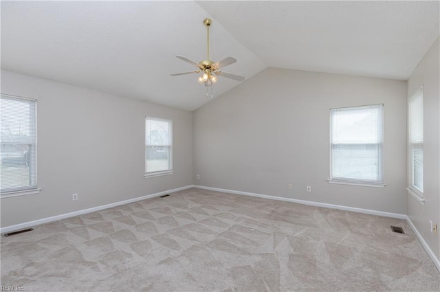 spare room with light carpet, ceiling fan, visible vents, and lofted ceiling