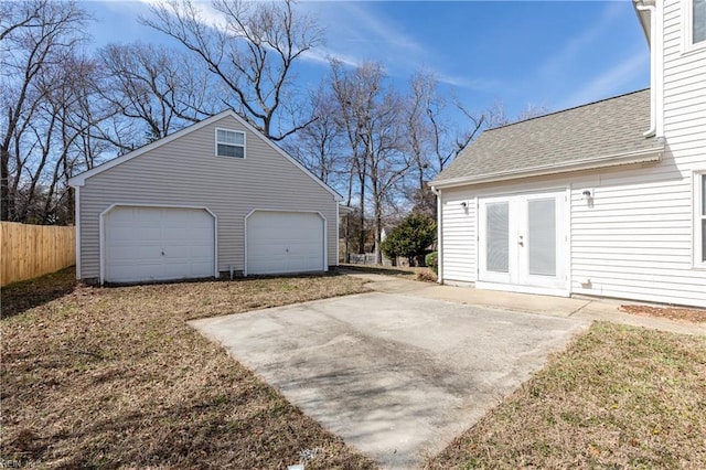 garage featuring french doors and fence