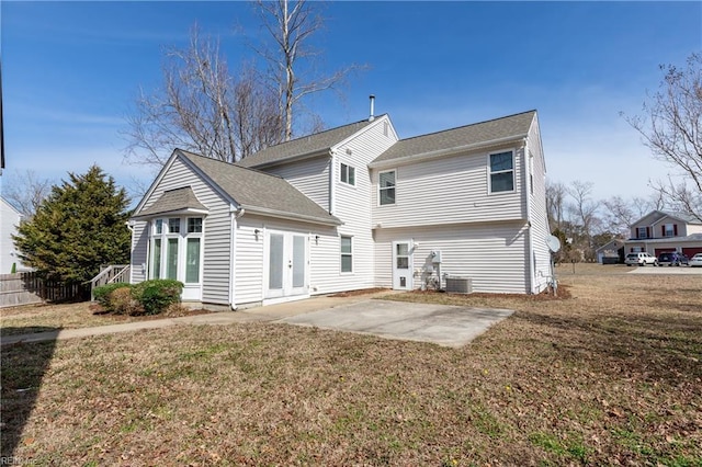 back of property with french doors, a patio area, a yard, and fence