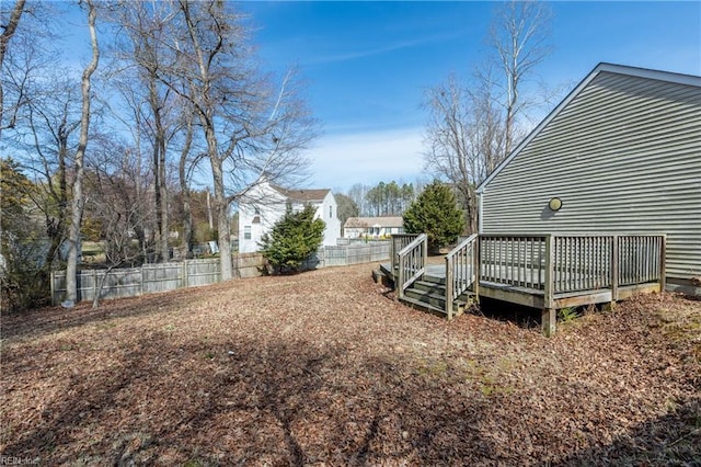 view of yard with a deck and fence