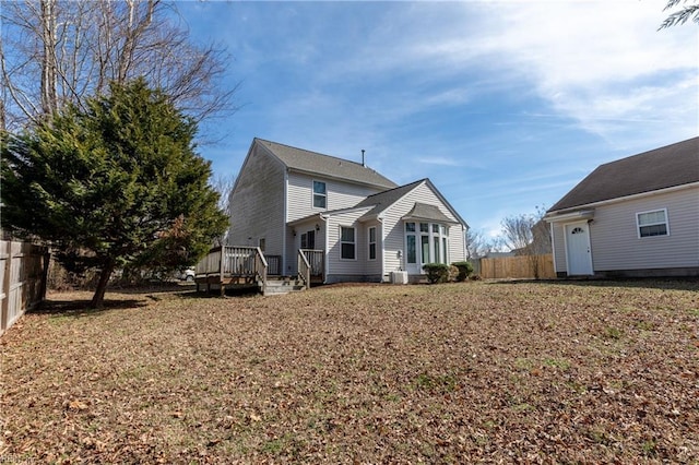 back of house with fence, a deck, and central air condition unit