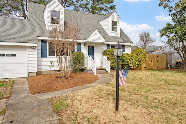 cape cod home featuring an attached garage, roof with shingles, a front lawn, and fence