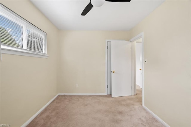 unfurnished bedroom featuring baseboards, carpet, and a ceiling fan