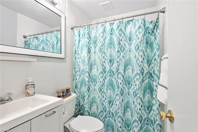 bathroom featuring vanity, a shower with curtain, visible vents, tile walls, and toilet