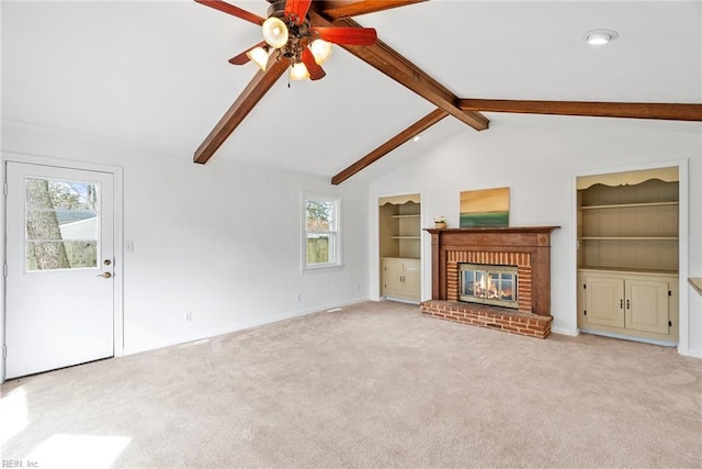 unfurnished living room featuring built in features, lofted ceiling with beams, a fireplace, ceiling fan, and light colored carpet