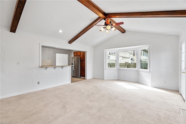 unfurnished living room featuring light colored carpet, ceiling fan, and vaulted ceiling with beams