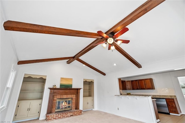 unfurnished living room with built in features, vaulted ceiling with beams, a fireplace, ceiling fan, and light carpet