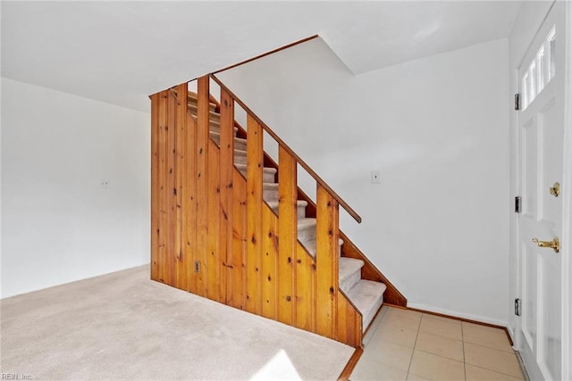 stairway featuring carpet flooring