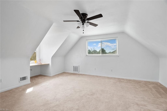 additional living space featuring visible vents, carpet floors, and vaulted ceiling