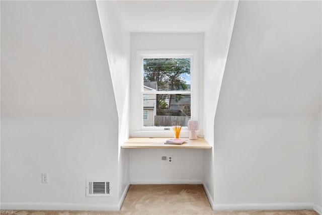 interior details featuring visible vents, built in desk, carpet floors, and baseboards