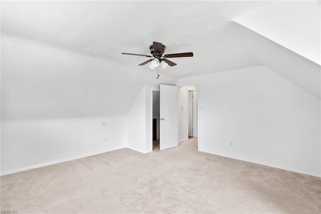 bonus room with ceiling fan, vaulted ceiling, and light carpet