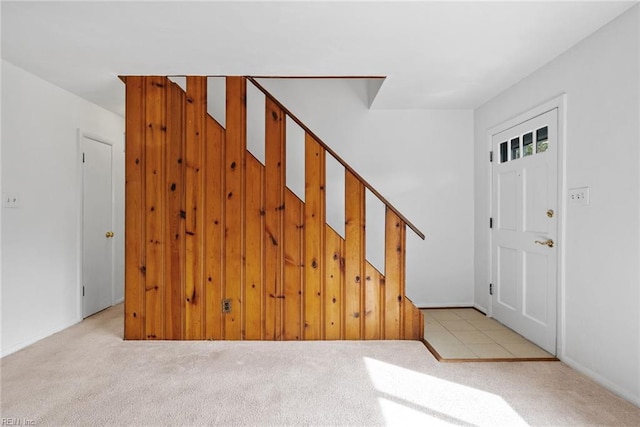 foyer entrance featuring light carpet