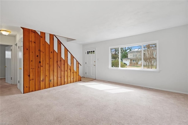 interior space with stairway and carpet