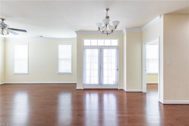 unfurnished room featuring dark wood-style floors, plenty of natural light, baseboards, and crown molding