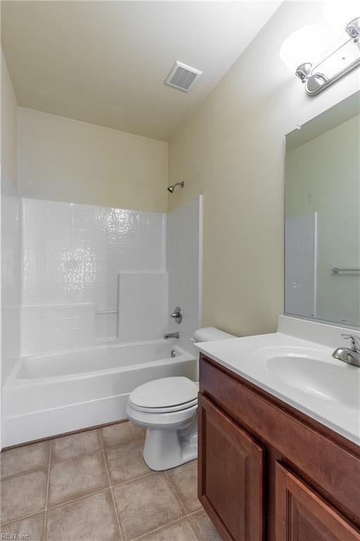 bathroom featuring visible vents, toilet, tile patterned floors, bathtub / shower combination, and vanity