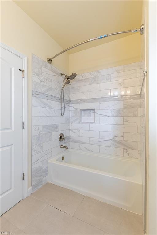 bathroom featuring tile patterned flooring and washtub / shower combination