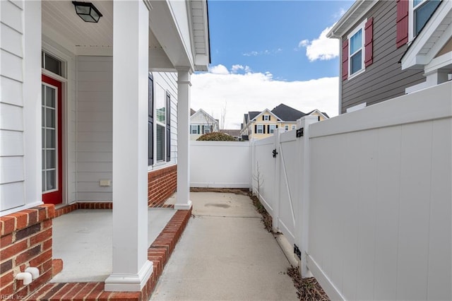 view of patio / terrace with a porch, a gate, and fence