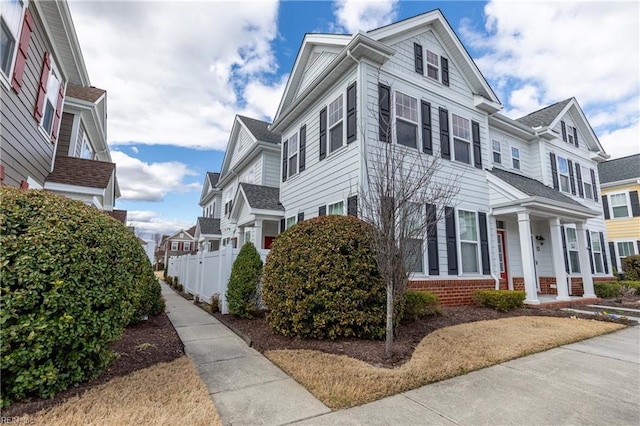 view of home's exterior with a residential view and fence