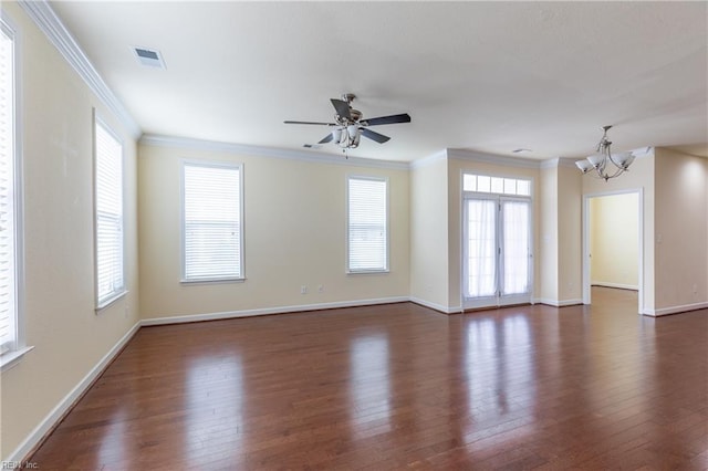 spare room with dark wood-style floors, a wealth of natural light, and crown molding