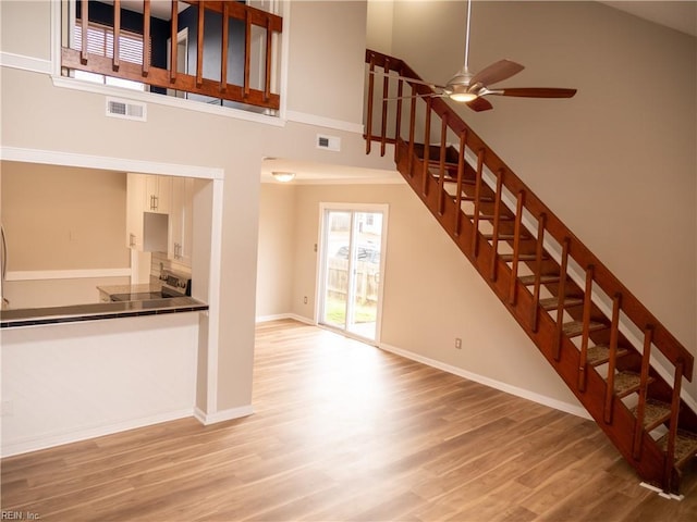 interior space with visible vents, high vaulted ceiling, and wood finished floors