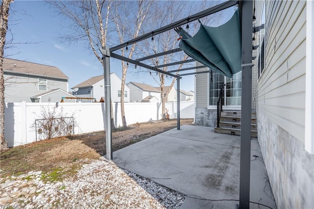 view of patio with entry steps, a fenced backyard, and a residential view