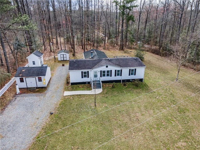 drone / aerial view featuring a forest view