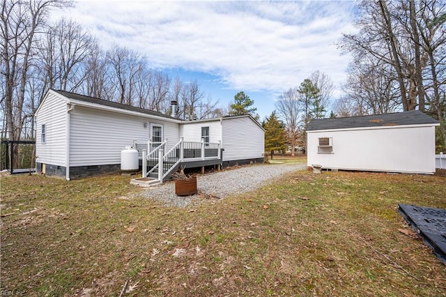 back of house featuring a yard, crawl space, and a wooden deck