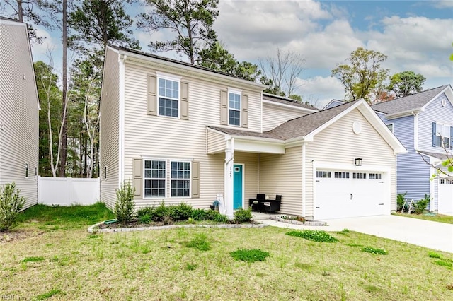 traditional-style house with a garage, fence, a front lawn, and concrete driveway