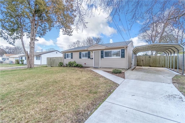 single story home with driveway, a detached carport, fence, and a front yard