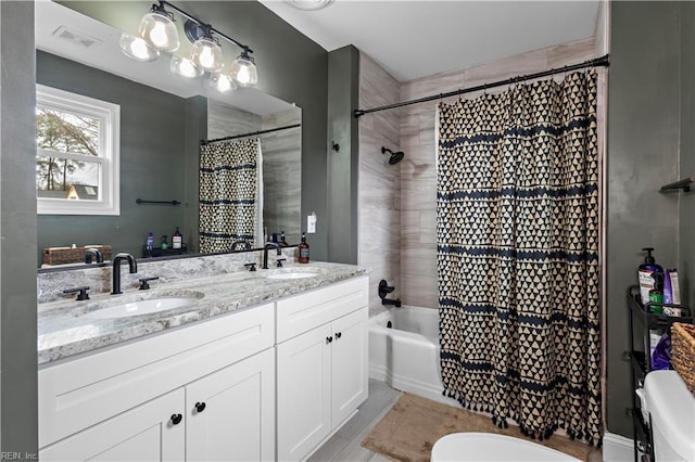 bathroom featuring shower / tub combo, visible vents, a sink, and double vanity