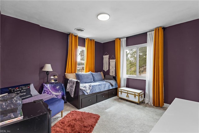 carpeted bedroom featuring multiple windows and visible vents