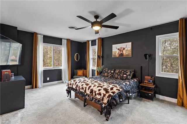 bedroom with carpet floors, multiple windows, and visible vents