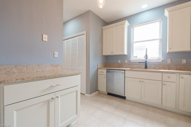 kitchen featuring light stone counters, recessed lighting, a sink, baseboards, and dishwasher