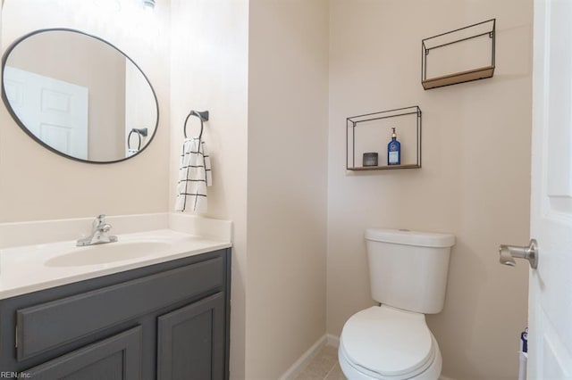 half bathroom with toilet, baseboards, and vanity