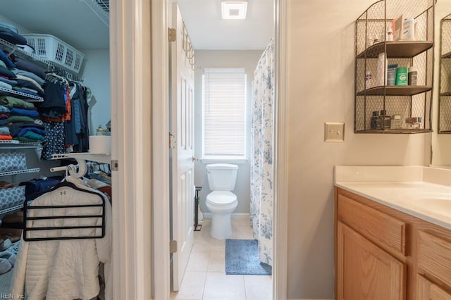 bathroom featuring visible vents, vanity, toilet, and tile patterned floors