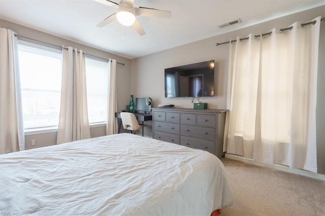 bedroom with carpet flooring, visible vents, and a ceiling fan