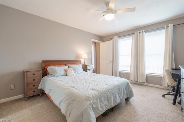 bedroom with light carpet, a ceiling fan, and baseboards