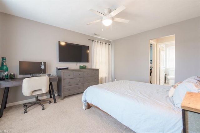 carpeted bedroom featuring baseboards, visible vents, a ceiling fan, and ensuite bathroom