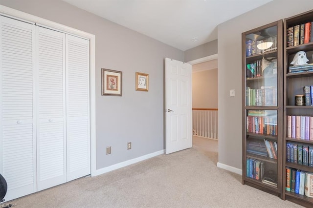 bedroom featuring carpet, baseboards, and a closet