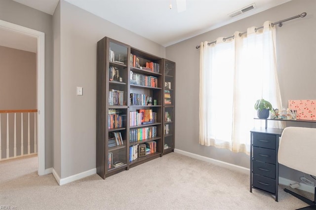 office area with baseboards, visible vents, and light colored carpet