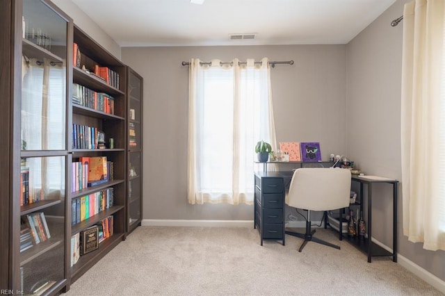 office space with carpet floors, visible vents, and baseboards