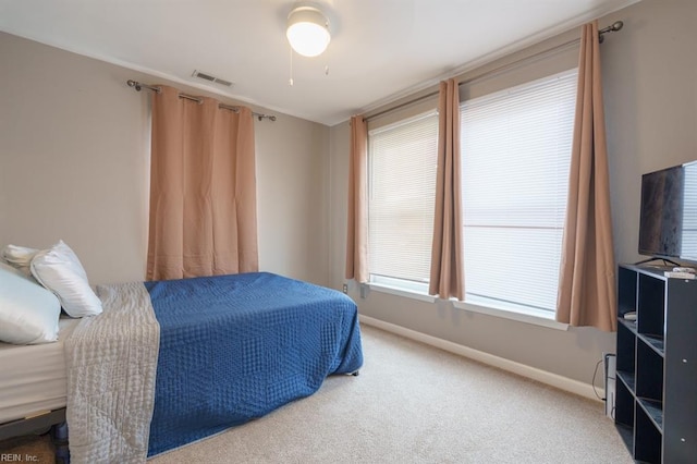 carpeted bedroom featuring visible vents and baseboards