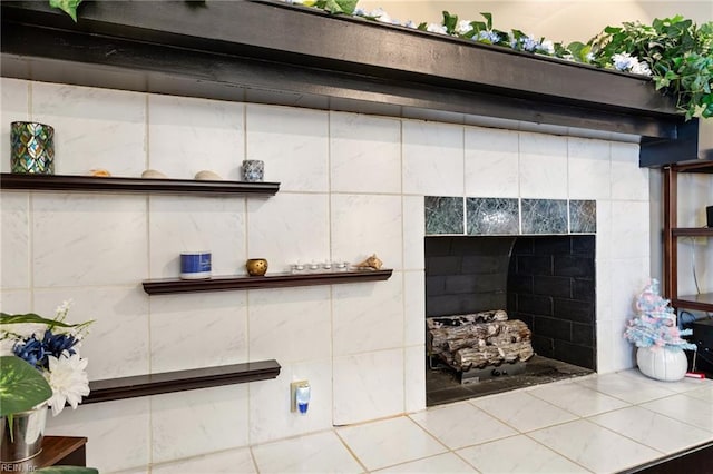 interior details featuring a tile fireplace