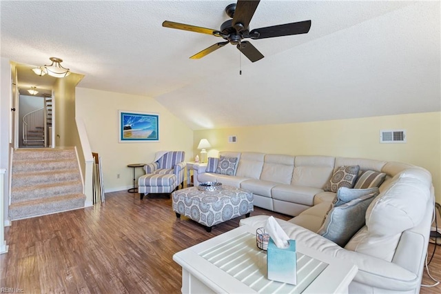 living room featuring a textured ceiling, wood finished floors, visible vents, vaulted ceiling, and stairs