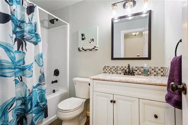 full bath featuring shower / bath combination with curtain, tasteful backsplash, vanity, and toilet