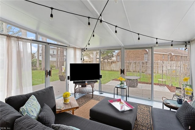 sunroom featuring lofted ceiling